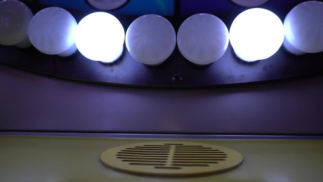 A series of lights that make a perfect pattern in synchronization and create a cool piece of art. Upfront, you have a small speaker.