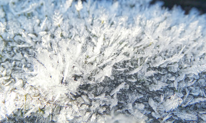 winter background with snowflakes crystals patterns and snow on frozen grass
