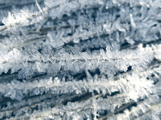 winter background with snowflakes crystals patterns and snow on frozen grass