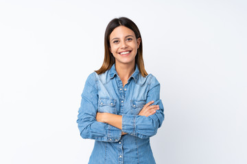 Young woman over isolated white background keeping the arms crossed in frontal position
