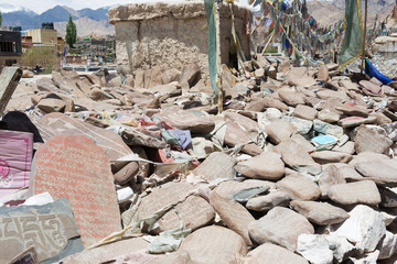 Ladakh, India - Jul 03 2019 - Mani Stone at Choglamsar Town in Ladakh, Jammu and Kashmir, India. Mani stones are stone plates as a form of prayer in Tibetan Buddhism.