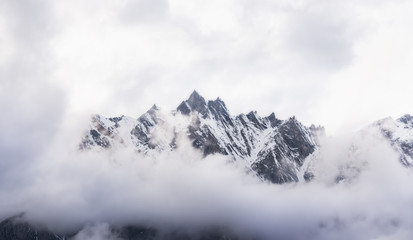 Panoramic snow mountain with white cloudy sky - Powered by Adobe