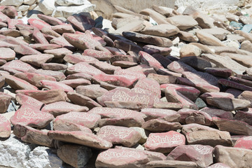 Ladakh, India - Jul 03 2019 - Mani Stone at Choglamsar Town in Ladakh, Jammu and Kashmir, India. Mani stones are stone plates as a form of prayer in Tibetan Buddhism.