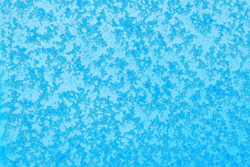 Beautiful close up view of natural snow pattern on blue background. Beautiful backgrounds texture. 