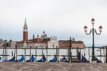 Fototapeta na wymiar Gondolas and view towards the San Giorgo Maggiore church from the piazzetta San Marco in Venice, Italy