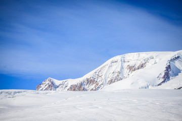 Fototapeta na wymiar Magnificent view of the snow-white tall mighty mountains Elbrus, ski resort, the Republic of Kabardino-Balkaria, Russia