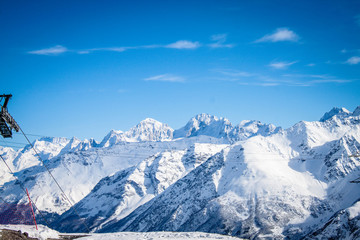 Obraz premium Magnificent view of the snow-white tall mighty mountains Elbrus, ski resort, the Republic of Kabardino-Balkaria, Russia