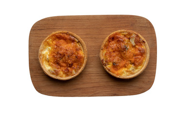 Two small homemade quiches on a board