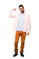 Full-length shot of Handsome man with beard doing strong gesture over isolated white background