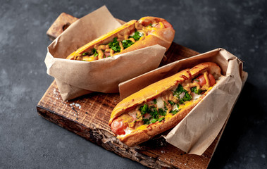 french hot dogs from the store  packed in paper, baked with cheese and mustard on a stone...