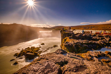 Fototapeta na wymiar Goðafoss in long exposer, blue sky, warm autumn colors in the sun