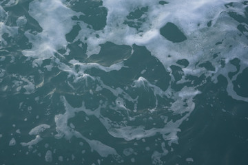 The texture of sea water and foam. Blue waves. Creative vintage background.