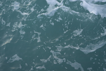 The texture of sea water and foam. Blue waves. Creative vintage background.