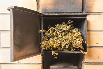 Dry birch broom lies in the oven to ignite the fire in the bath
