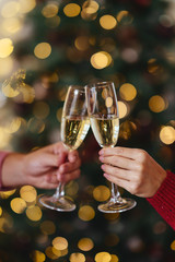 Man and woman hands with full champagne glasses