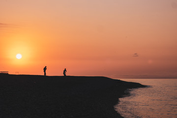 Fototapeta na wymiar silhouette of man on beach at sunset, batumi, Black sea