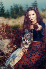 Shaman woman and shamanic feathers on denim.