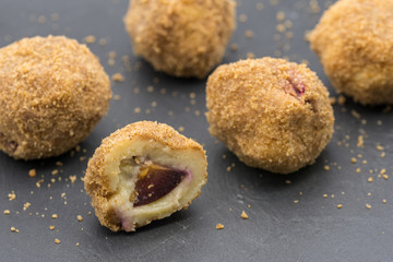 delicious dessert plum filled dumplings served on slate