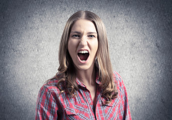 Frenzied young woman screaming with anger.