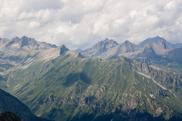 Fototapeta premium Panorama of mountains scene with dramatic cloudy sky in national park of Dombay