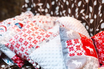 cushions with Christmas winter pattern red and white on the sofa