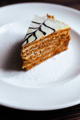 carrot cake with walnuts, prunes and dried apricots on a dark wood background. tinting. selective focus