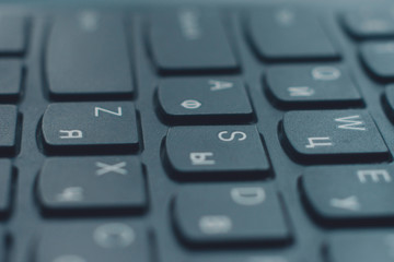 Obraz premium Closeup black keyboard with Ukrainian and English alphabet layout.