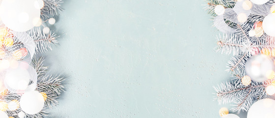 Light blue Christmas or New Year festive banner with frosty fir branches
