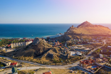 Sudak city in Crimea overlooking the castle hill with a fort on it