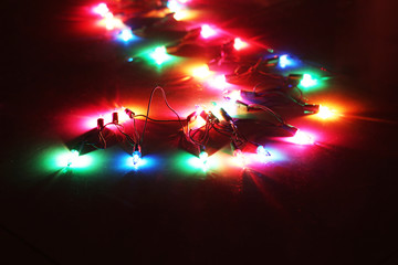 blurred shining colourful garlands as christmas background (celebration concept)