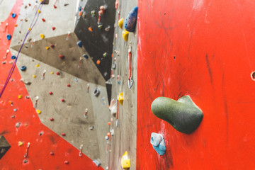 steep rock, climbing on artificial wall indoors. Extreme sports and bouldering concept.