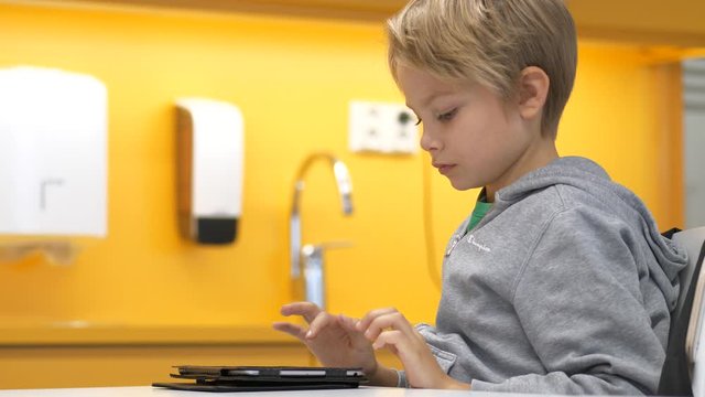 Nordic elementary school boy studiying and raising hand during class, Slow motion