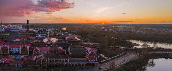 Panorama with a view from above on an industrial area with a paper mill at sunset in late autumn