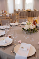 Food served on table in a white hall during a wedding reception in Eastern European Baltic Riga Latvia - Biege, creme and pink colors with name signs on dishes - Canape, snacks and light drinks