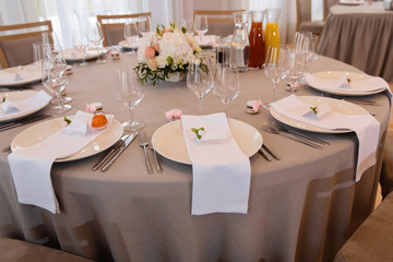 Food served on table in a white hall during a wedding reception in Eastern European Baltic Riga Latvia - Biege, creme and pink colors with name signs on dishes - Canape, snacks and light drinks