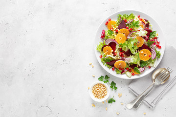 Christmas salad with boiled beet, red onion, tangerines, pomegranate, parsley, pine nuts and...