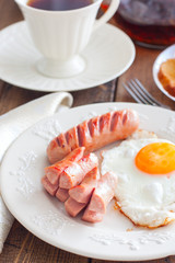 Fried sausages with fried eggs, selective focus