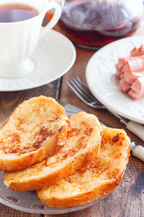 Toasted white bread on a plate on a wooden table, selective focus