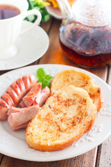 Toasted white bread on a plate on a wooden table, selective focus