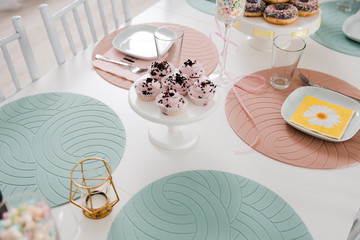 Food served on table in a white hall during a children Birthday party decoration in Eastern European Baltic Riga Latvia - Mild Biege, creme, pink colors - Canape, snacks and light drinks