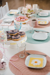Food served on table in a white hall during a children Birthday party decoration in Eastern European Baltic Riga Latvia - Mild Biege, creme, pink colors - Canape, snacks and light drinks
