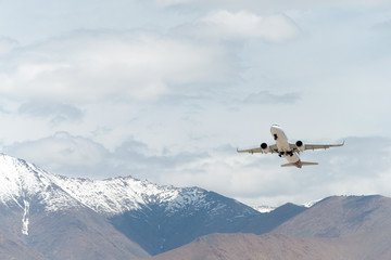 Fototapeta na wymiar Ladakh, India - Jul 09 2019 - Vistara Airbus A320neo flying in the sky from Leh airport (Kushok Bakula Rimpochee Airport) view from Spituk Monastery in Ladakh, Jammu and Kashmir, India.