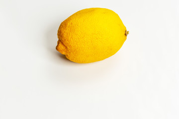 Faded stale lemon on a white background close up.