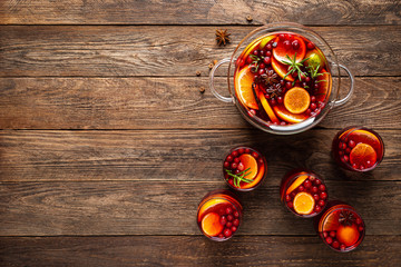 Christmas punch. Festive red cocktail, drink with cranberries and citrus fruits in a punch bowl and glasses