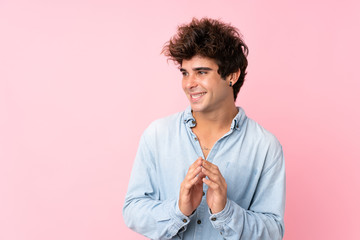 Young caucasian man with jean shirt over isolated pink background scheming something