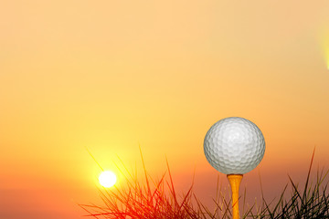 golf ball on tee on green background of sky