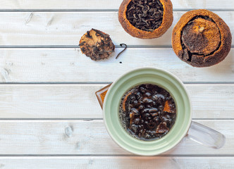 Pu-erh tea aged in tangerine and glass ceramic teapot on a wood place. the view from the top