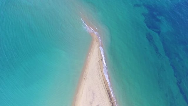 Akra Epanomi - The end of the sand beach and turquoise sea on the both sides of the beach 