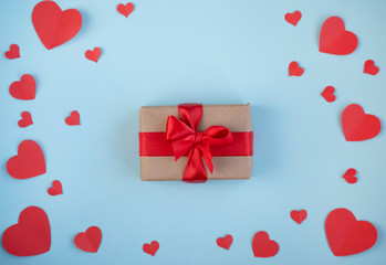 The Background Of Valentine's Day.Gift in a box with a red ribbon, red hearts, a Declaration of love on a light background. The Concept Of Valentine's Day. top view, copy space