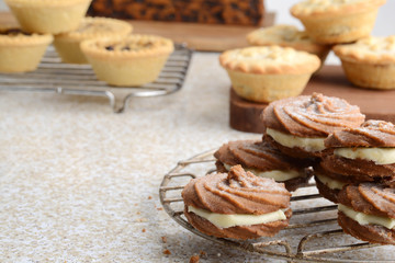 swirl gingerbread cookies with christmas desserts in background